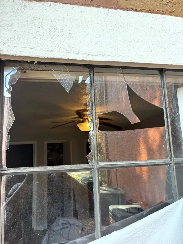 Shattered pane in a bronze-frame window